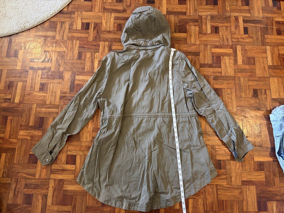 khaki hooded utility jacket (Category: Coats, Jackets and Outerwear) located in Quezon City. Submitted by shopsoph (Listing ID 1446875681, Image 3). Description: - Khaki green hooded jacket from Cotton On - Features a drawstring waist for a customizable fit - Multiple functional pockets on the front - Ideal for layering over outfits - Measurements: Pit to pit approx. 21 inches, Length approx. 31 inches.