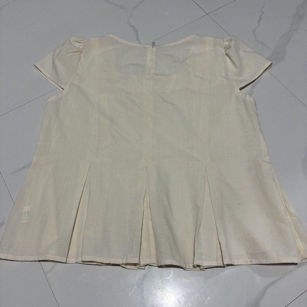 Cream Square Neck Puff Sleeve Pleated Top (Category: Blouses) located in Magalang. Submitted by dclutter_ki (Listing ID 1446752408, Image 2). Description: Best fit up to 37 bust max Material: Linen blend (giving maharlika vibes hahaha) Cream top with square neck, puff sleeves, and front pleats. Button back closure..