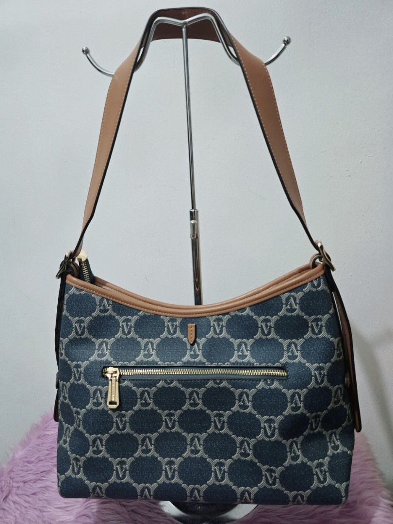 Denim Monogram Shoulder Bag with Tan Leather Trim (Category: Shoulder Bags) located in Pasig City. Submitted by zealfish.3d4f32 (Listing ID 1446724680, Image 2). Description: - Cute denim shoulder bag with repeating monogram pattern. - Tan leather trim and strap. - Front zip pocket for easy access. - Multiple interior compartments and a zip pocket for organization. - Spacious and ideal for everyday use..