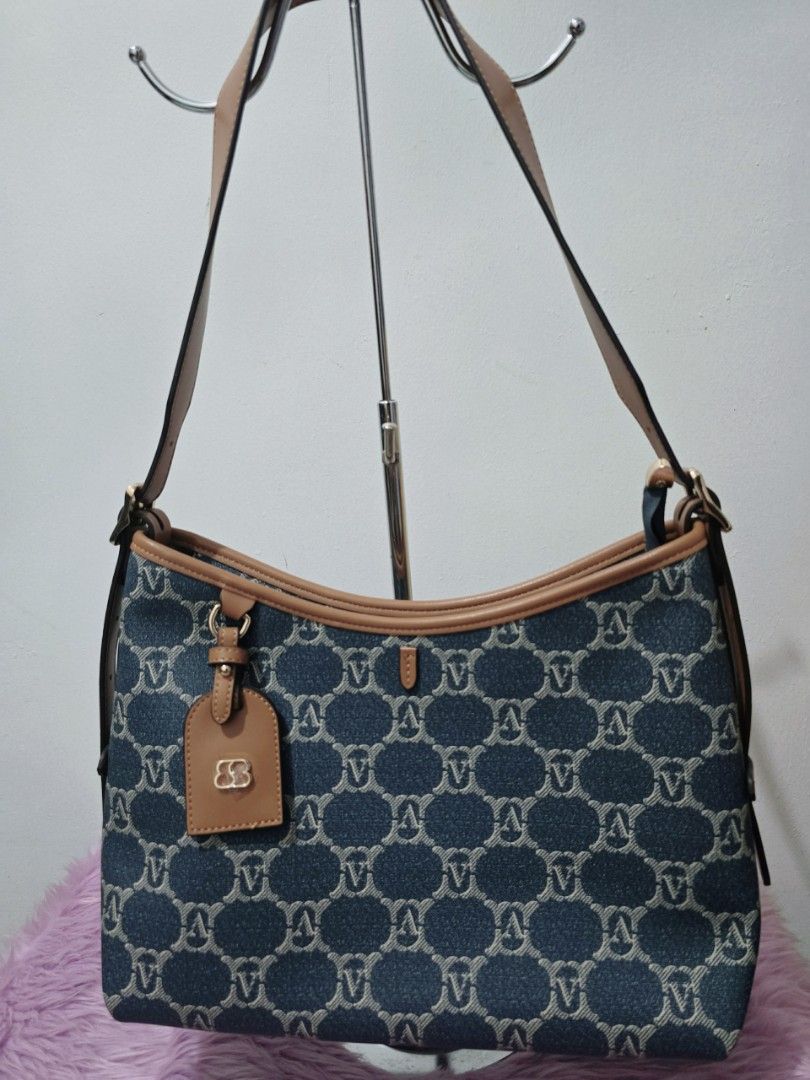 Denim Monogram Shoulder Bag with Tan Leather Trim (Category: Shoulder Bags) located in Pasig City. Submitted by zealfish.3d4f32 (Listing ID 1446724680, Image 1). Description: - Cute denim shoulder bag with repeating monogram pattern. - Tan leather trim and strap. - Front zip pocket for easy access. - Multiple interior compartments and a zip pocket for organization. - Spacious and ideal for everyday use..