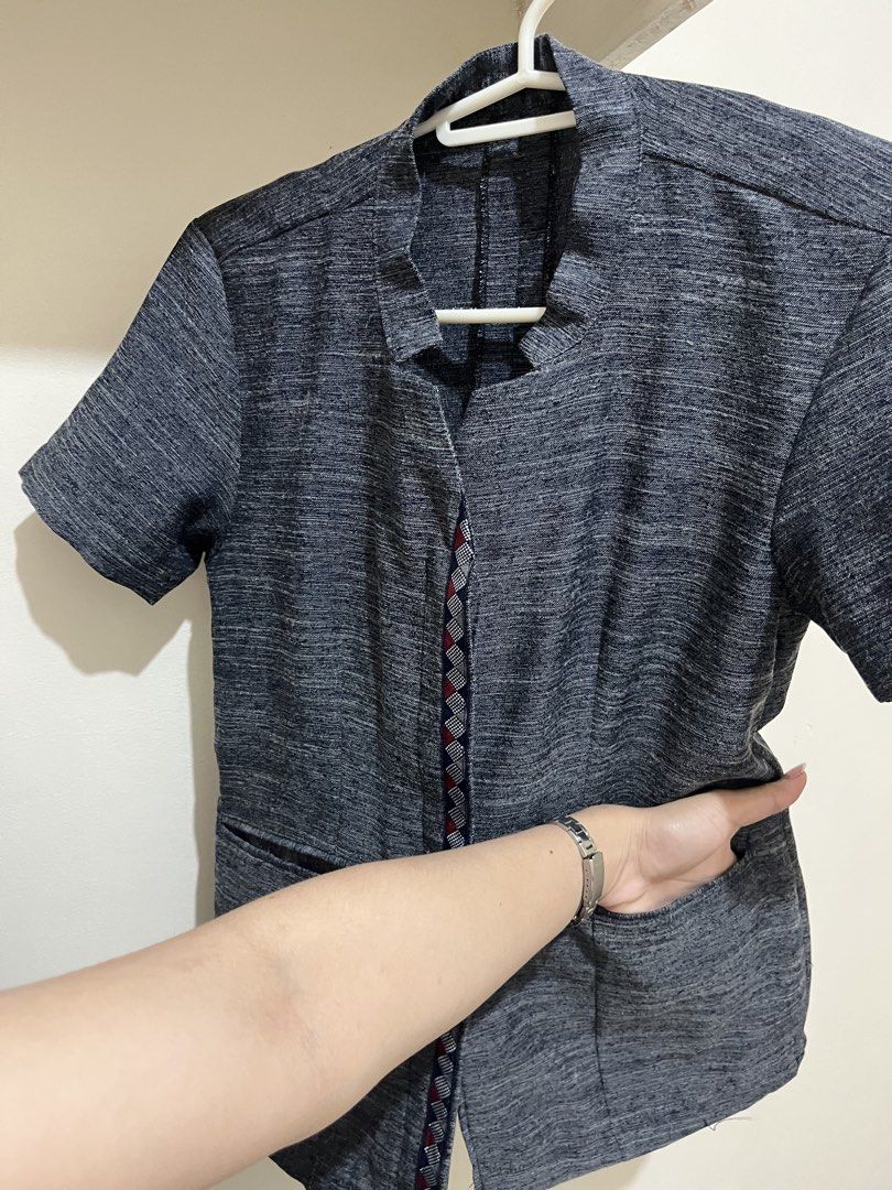 DepEd Tue/Thu blouse (Category: Blouses) located in Taguig. Submitted by milllooo (Listing ID 1446753104, Image 2). Description: -used twice kakagawa lang (hindi na kasya sakin) - Dark grey textured short sleeve blouse - Mandarin collar with V-neck opening - Two front pockets - Decorative geometric trim down the center front - Versatile for casual or work outfits - Easy to pair with various bottoms.
