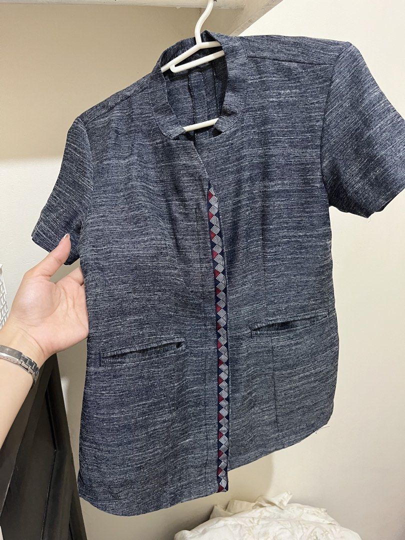 DepEd Tue/Thu blouse (Category: Blouses) located in Taguig. Submitted by milllooo (Listing ID 1446753104, Image 1). Description: -used twice kakagawa lang (hindi na kasya sakin) - Dark grey textured short sleeve blouse - Mandarin collar with V-neck opening - Two front pockets - Decorative geometric trim down the center front - Versatile for casual or work outfits - Easy to pair with various bottoms.