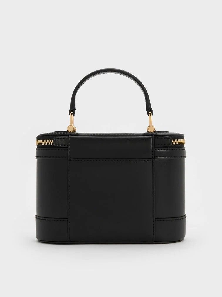 Enola Top Handle Vanity Bag - Black (Category: Announcements) located in Makati City. Submitted by zoeppe_online (Listing ID 1446908108, Image 3). Description: Enola Top Handle Vanity Bag - CANVAS LEATHER This is a Charles & Keith Enola Top Handle Vanity Bag in black, featuring a structured design and gold-tone double-zip closure Brand: Charles & KeithModel: Enola Top Handle Vanity BagColor: CANVAS LEATHER, BLACK NOIR, CREAM WHITE Features: Top h