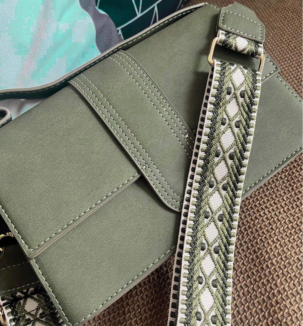 Green Crossbody Bag with Embroidered Strap (Category: Cross-body Bags) located in Muntinlupa City. Submitted by lovextended (Listing ID 1446727896, Image 1). Description: - Olive green crossbody bag - Flap closure with stitching details - Wide, adjustable strap - Strap features a cool embroidered pattern (green, white, black) - Ideal for everyday use - Fits all your essentials.