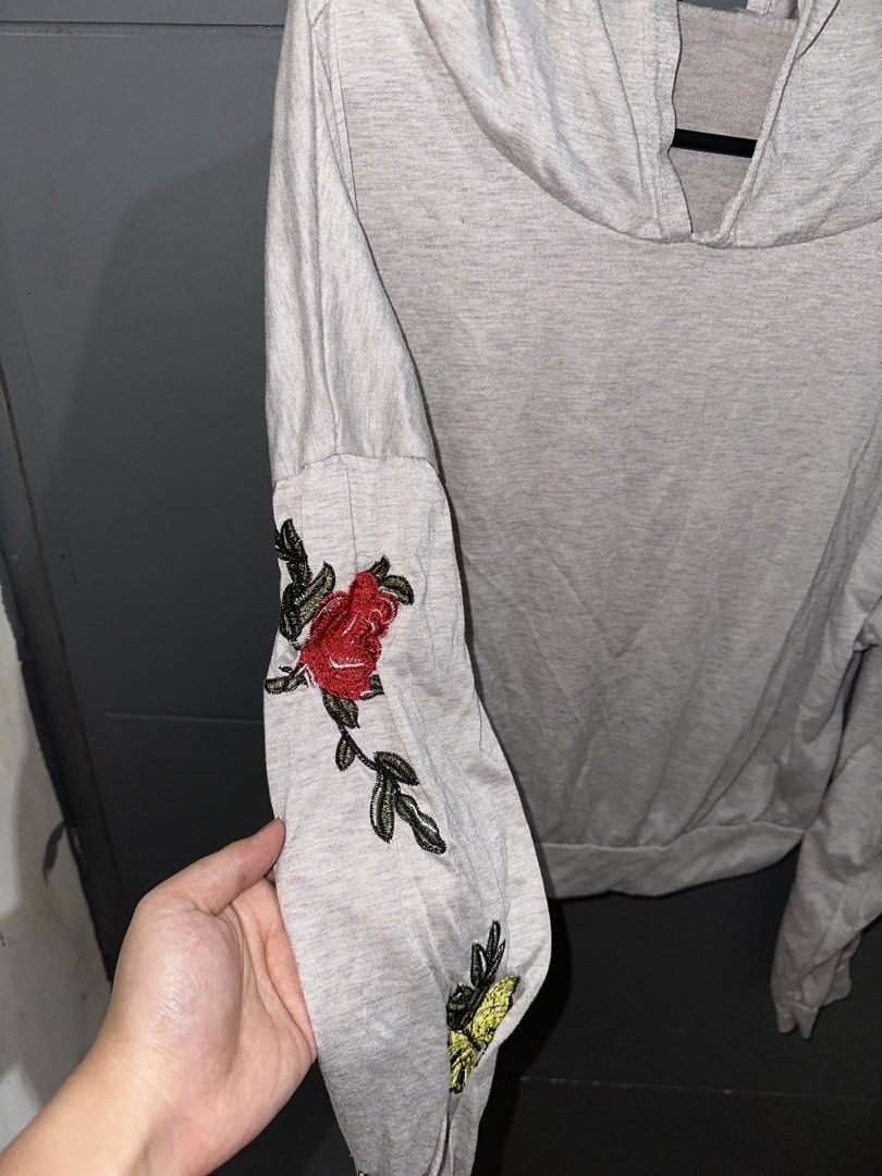 Grey Hoodie w/ Flowers (Category: Coats, Jackets and Outerwear) located in Rizal. Submitted by ryannesua47021 (Listing ID 1446858866, Image 2). Description: - Light grey hoodie - Embroidered floral and butterfly details on sleeves - Long sleeves with elasticated cuffs - Hooded neckline - Casual and comfortable for everyday wear - Easy to style with jeans or leggings.
