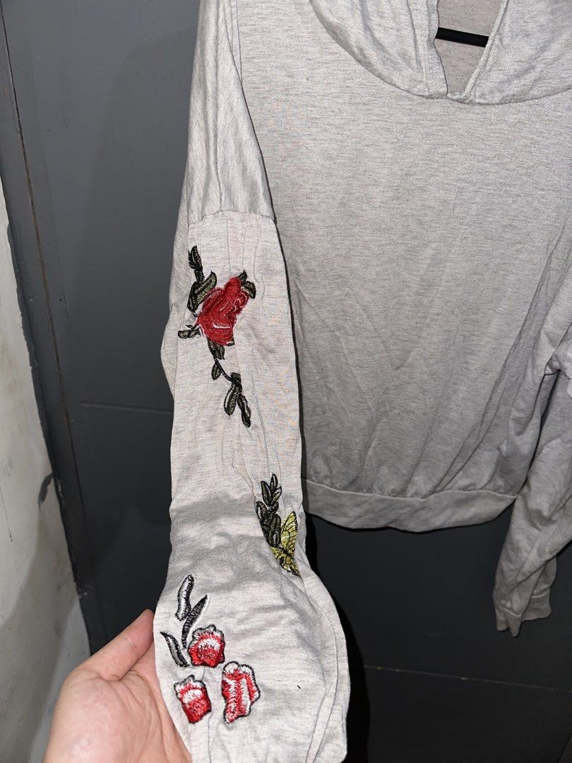 Grey Hoodie w/ Flowers (Category: Coats, Jackets and Outerwear) located in Rizal. Submitted by ryannesua47021 (Listing ID 1446858866, Image 3). Description: - Light grey hoodie - Embroidered floral and butterfly details on sleeves - Long sleeves with elasticated cuffs - Hooded neckline - Casual and comfortable for everyday wear - Easy to style with jeans or leggings.