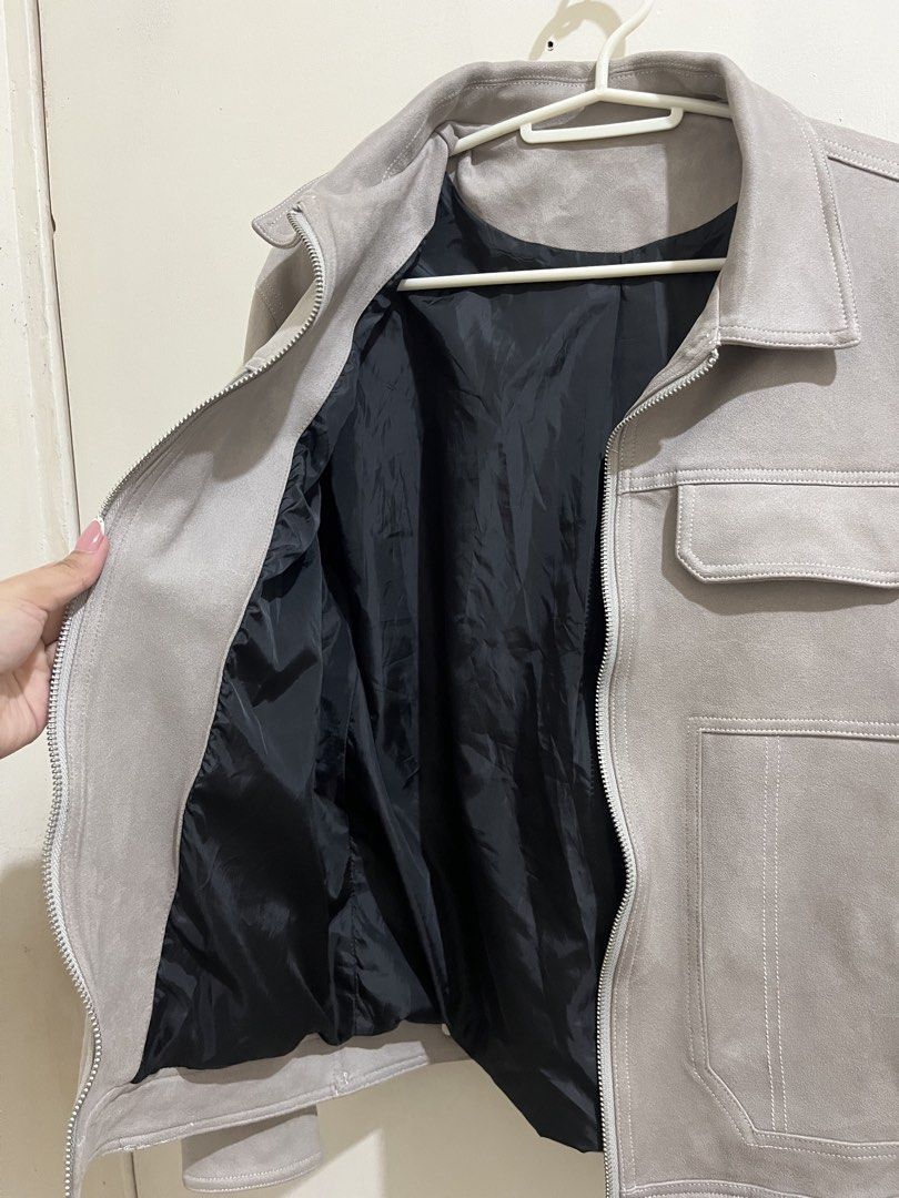 Grey Suede Zip-Up Jacket with Pocket Details (Category: Coats, Jackets and Outerwear) located in Taguig. Submitted by milllooo (Listing ID 1446753855, Image 3). Description: - Stylish cool grey jacket - Features a zip-up front - Two chest pockets and side pockets - Lined with black fabric for comfort - Button detail on the cuffs - Ideal for layering over outfits.