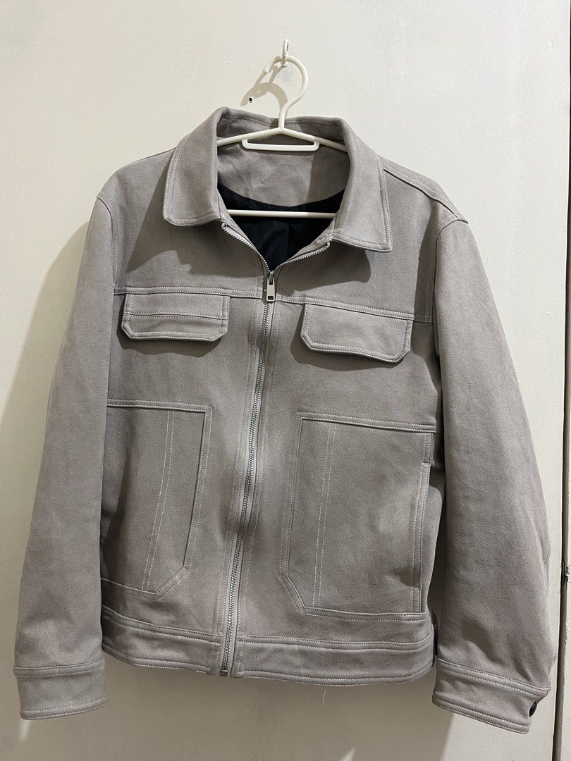 Grey Suede Zip-Up Jacket with Pocket Details (Category: Coats, Jackets and Outerwear) located in Taguig. Submitted by milllooo (Listing ID 1446753855, Image 1). Description: - Stylish cool grey jacket - Features a zip-up front - Two chest pockets and side pockets - Lined with black fabric for comfort - Button detail on the cuffs - Ideal for layering over outfits.