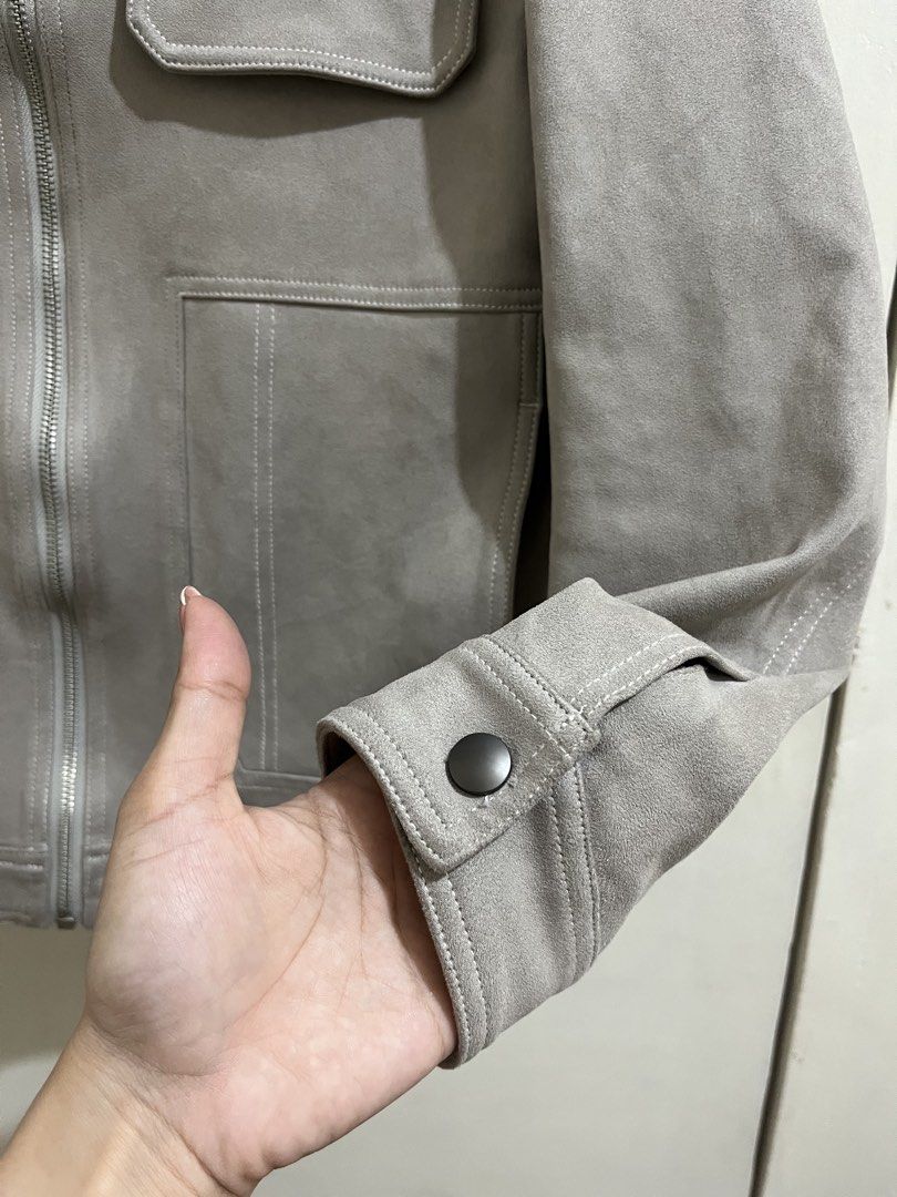 Grey Suede Zip-Up Jacket with Pocket Details (Category: Coats, Jackets and Outerwear) located in Taguig. Submitted by milllooo (Listing ID 1446753855, Image 2). Description: - Stylish cool grey jacket - Features a zip-up front - Two chest pockets and side pockets - Lined with black fabric for comfort - Button detail on the cuffs - Ideal for layering over outfits.