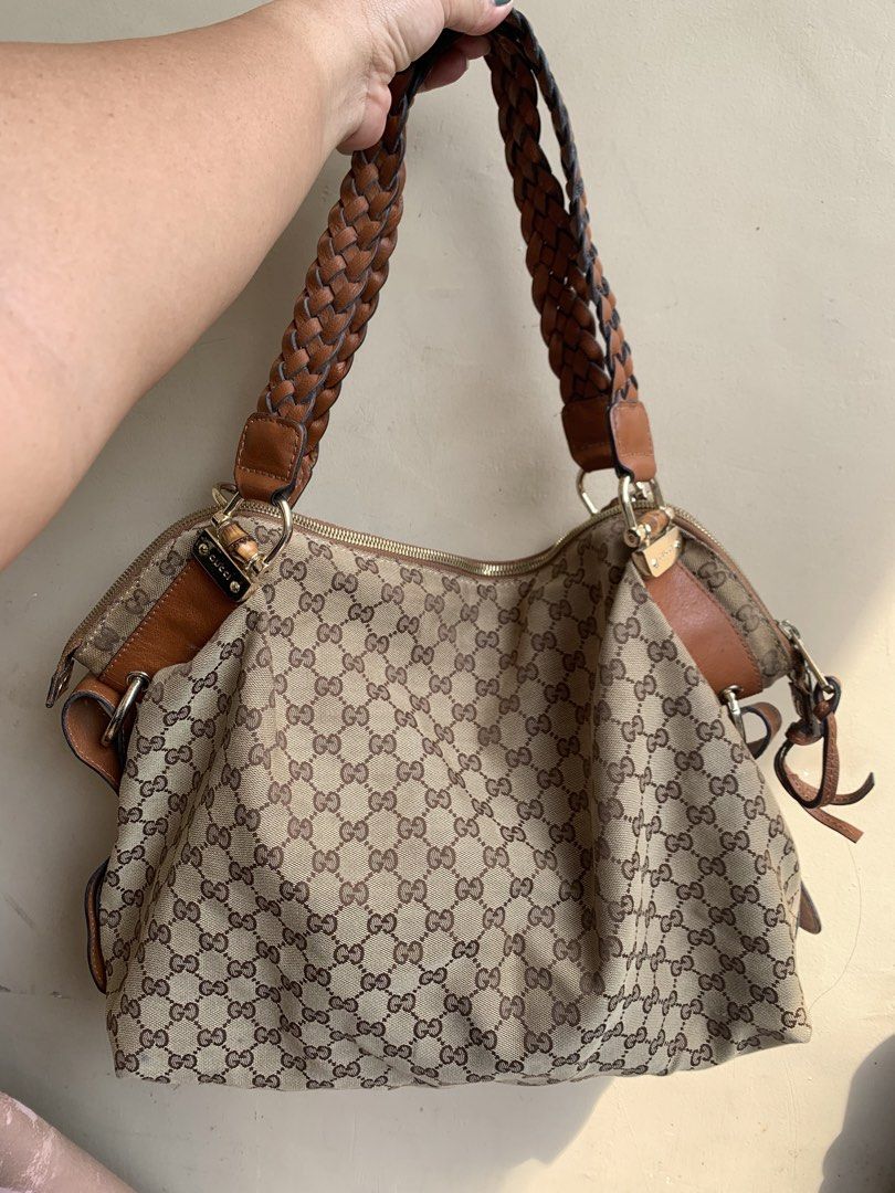 Gucci Monogram Canvas Shoulder Bag with Braided Straps (Category: Luxury Bags & Wallets) located in Liloan. Submitted by jinalyns (Listing ID 1446736848, Image 1). Description: Gucci shoulder bag - Classic GG monogram canvas - Brown leather trim - Braided shoulder straps - Gold-tone hardware with Gucci logo details - Zipper closure - Shows some signs of wear on hardware and leather.