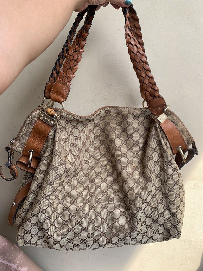 Gucci Monogram Canvas Shoulder Bag with Braided Straps (Category: Luxury Bags & Wallets) located in Liloan. Submitted by jinalyns (Listing ID 1446736848, Image 2). Description: Gucci shoulder bag - Classic GG monogram canvas - Brown leather trim - Braided shoulder straps - Gold-tone hardware with Gucci logo details - Zipper closure - Shows some signs of wear on hardware and leather.