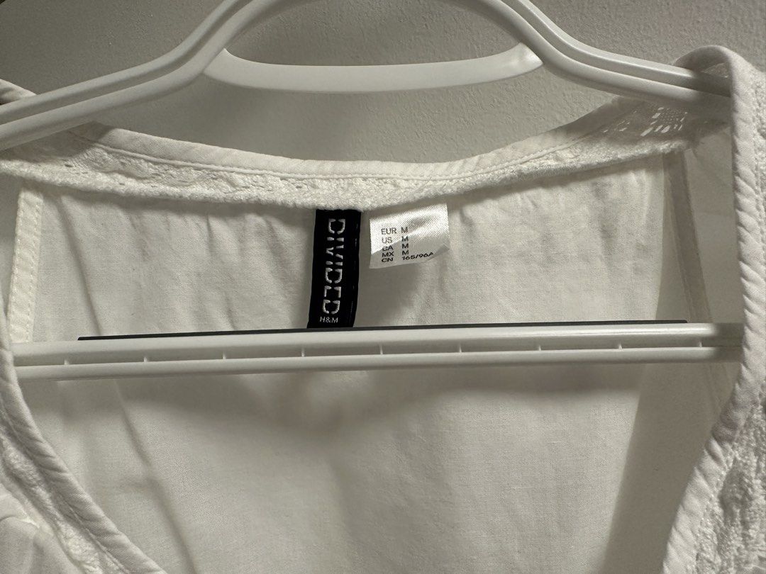 H&M Divided White Ruffle Peplum Top Size M (Category: Sleeveless) located in Marikina City. Submitted by saavi94 (Listing ID 1446893299, Image 2). Description: - White peplum top from H&M Divided - Sleeveless with ruffled neckline and cap sleeves - Pintuck details on the front - Ruffled hem with lace trim - Newly washed MOP: GCash MOD: Gogo Xpress.