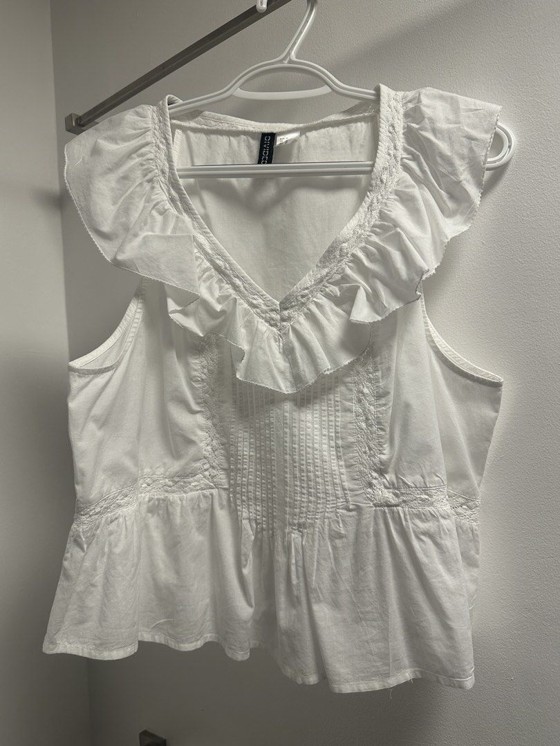 H&M Divided White Ruffle Peplum Top Size M (Category: Sleeveless) located in Marikina City. Submitted by saavi94 (Listing ID 1446893299, Image 1). Description: - White peplum top from H&M Divided - Sleeveless with ruffled neckline and cap sleeves - Pintuck details on the front - Ruffled hem with lace trim - Newly washed MOP: GCash MOD: Gogo Xpress.