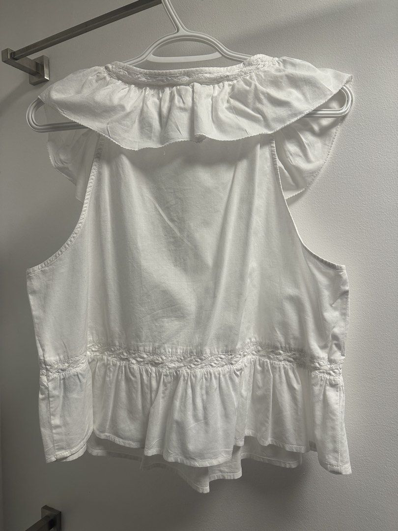 H&M Divided White Ruffle Peplum Top Size M (Category: Sleeveless) located in Marikina City. Submitted by saavi94 (Listing ID 1446893299, Image 3). Description: - White peplum top from H&M Divided - Sleeveless with ruffled neckline and cap sleeves - Pintuck details on the front - Ruffled hem with lace trim - Newly washed MOP: GCash MOD: Gogo Xpress.