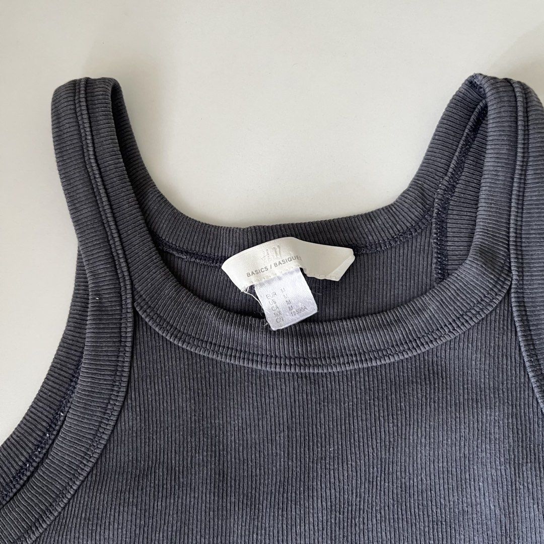 H&M Ribbed Tank Top - Charcoal Grey (Category: Sleeveless) located in Manila. Submitted by may077. (Listing ID 1446792574, Image 2). Description: - Basic ribbed tank top from H&M - Color: Charcoal Grey - Features: High neckline, racerback style - Material: Stretchy and comfortable - Versatile: Great for layering or wearing on its own - Style: Easy to match with any outfit.