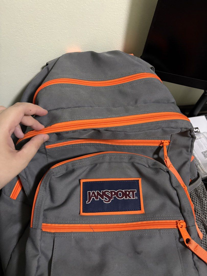 Jansport Grey Backpack with Orange Accents (Category: Backpacks) located in Quezon City. Submitted by shereegonzales (Listing ID 1446818135, Image 2). Description: - Classic Jansport backpack (Big Student) - Color: Grey with bright orange zippers and straps/Navy Blue - Features: Two main compartments, one front pocket - Comfort: Padded shoulder straps - Ideal for: School, everyday use - Condition: Minor marks on the front (please check photos) -N