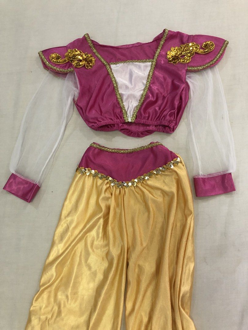 Kids Jasmine Princess Costume (Category: Babies & Kids Fashion) located in San Pedro. Submitted by tipbox (Listing ID 1446903567, Image 3). Description: - Adorable princess costume set - Includes pink top with gold trim and sheer sleeves - White inset and gold shoulder embellishments on top - Comfortable gold harem pants with elastic waist and cuffs - Perfect for dress-up, parties, or any little fan!.