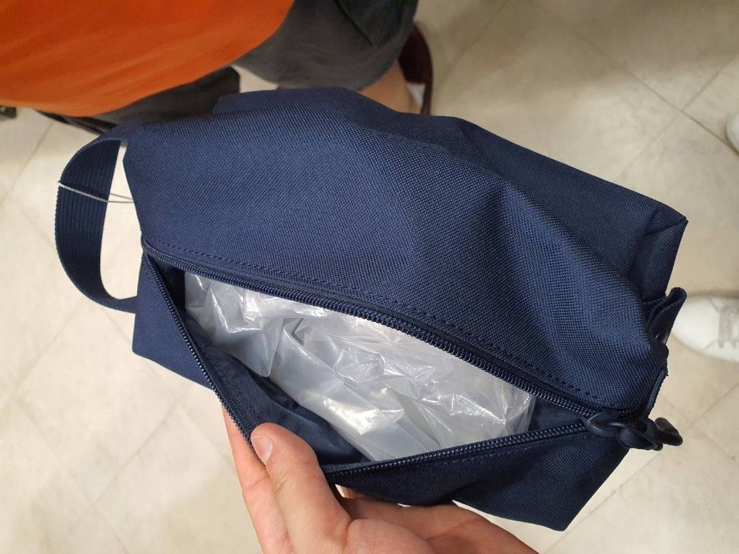 Lacoste Navy Blue Pouch Bag (Category: Luxury Bags & Wallets) located in Manila. Submitted by dominic000 (Listing ID 1446758276, Image 2). Description: Navy blue pouch from Lacoste. Has a main zippered compartment and a front zippered pocket. The material looks durable and water-resistant. Has a small handle on the side. Great for toiletries or small essentials. Measures about 9 inches long. PROMO!!!! brand new, original, not fake. never been use