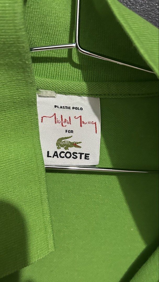 Lacoste x Michael Young Plastic Polo Shirt (Category: Tshirts & Polo Shirts ) located in San Fernando. Submitted by TheBTBs (Listing ID 1446896426, Image 2). Description: - Bright green polo shirt - Collaboration: Lacoste x Michael Young - Design: Short sleeves, collar, button placket - Features: Two large front pockets - Style: Ideal for casual wear Size: S-M frame ⚠️ Reminder Color may appear slightly different in photos due to lighting and scr