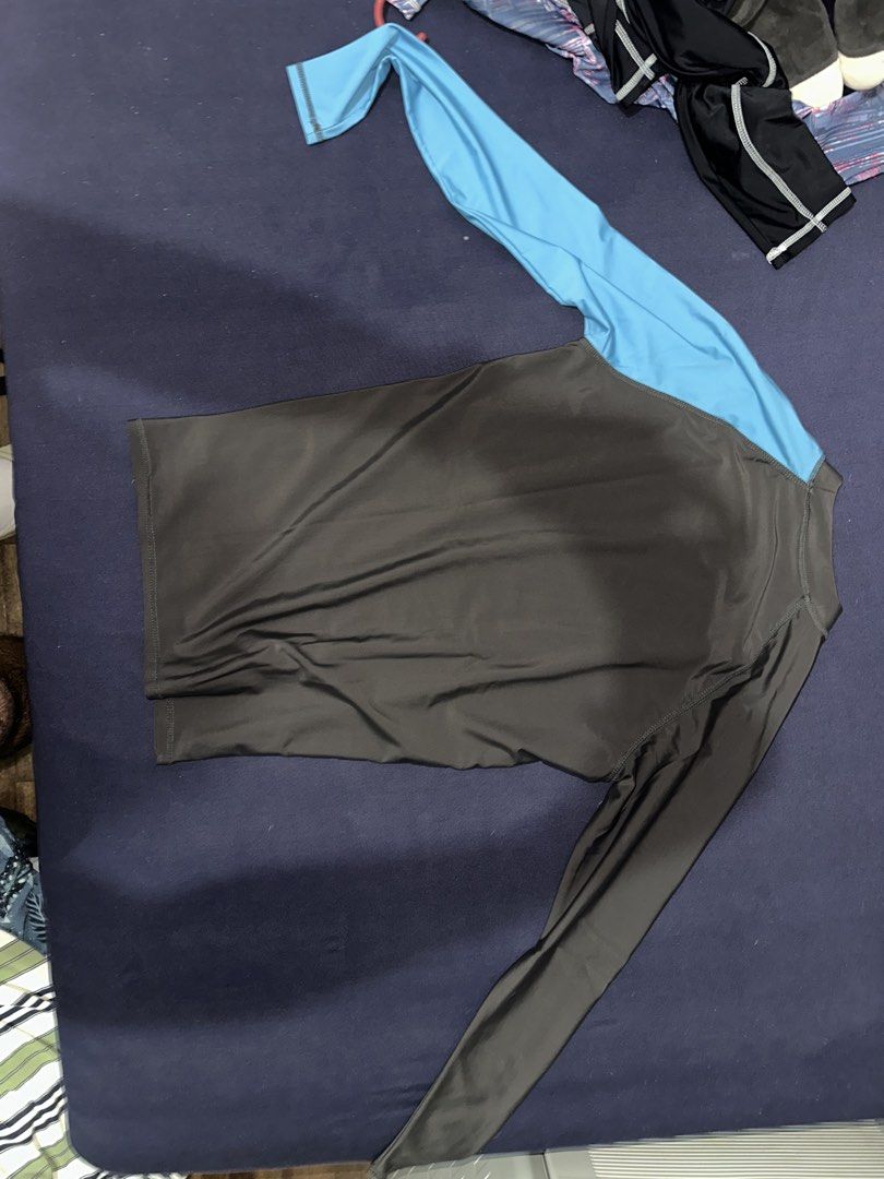 Long Sleeve Rash Guard - Dark Grey & Blue (Category: Swim Top & Rash Guards) located in Las Pinas. Submitted by inb.l (Listing ID 1446864359, Image 2). Description: P120 no size indicated on shirt but fits Mens Small no flaws SF care of buyer - Long sleeve rash guard - Dark grey body with blue sleeves - Features a graphic design on the front - Ideal for swimming and water sports - Stretchy and quick-drying fabric - Provides sun protection.