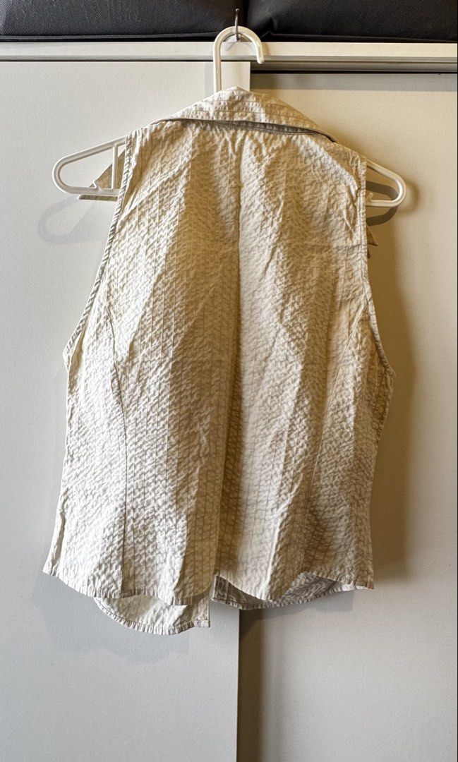 Mango Beige Textured Ruched Sleeveless Shirt (Category: Sleeveless) located in Pasig City. Submitted by pat.closetcleanup (Listing ID 1446868288, Image 2). Description: - Mango beige sleeveless shirt - Size: Medium - Textured fabric with subtle grid pattern - Ruched front with hook-and-eye closures - Collared neckline - Perfect for pairing with high-waisted bottoms - Worn twice.