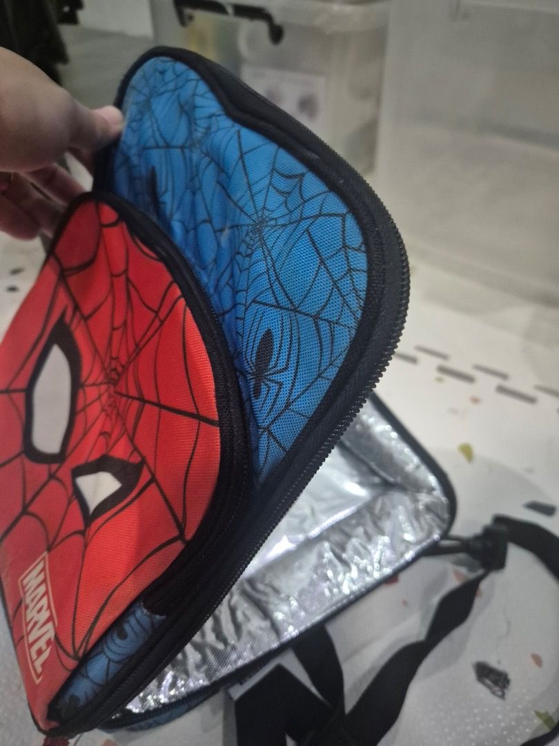 Marvel Spiderman Insulated Lunch Bag (Category: Other Babies Going Out Needs) located in Quezon City. Submitted by shopus2mnl (Listing ID 1446808526, Image 2). Description: - Awesome Spiderman design for kids! - Vibrant red exterior with Spiderman mask. - Fun blue interior featuring a web print. - Insulated lining keeps food fresh and cool. - Secure zipper closure for easy access. - Ideal for school lunches or fun outings..