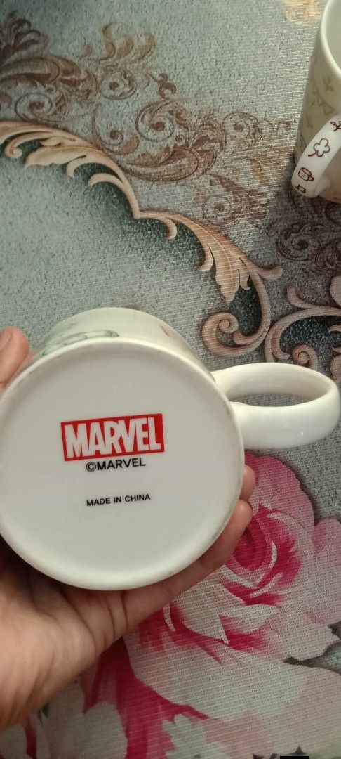 Marvel The Hulk Mug (Category: Coffee & Tea Tableware) located in Gapan. Submitted by montesnora80204 (Listing ID 1446869837, Image 3). Description: - Awesome Hulk mug for any Marvel fan! - Vibrant print on white ceramic. - Features Marvel logo on side and bottom. - Perfect for coffee or tea. - Dishwasher and microwave safe. - Made in China..