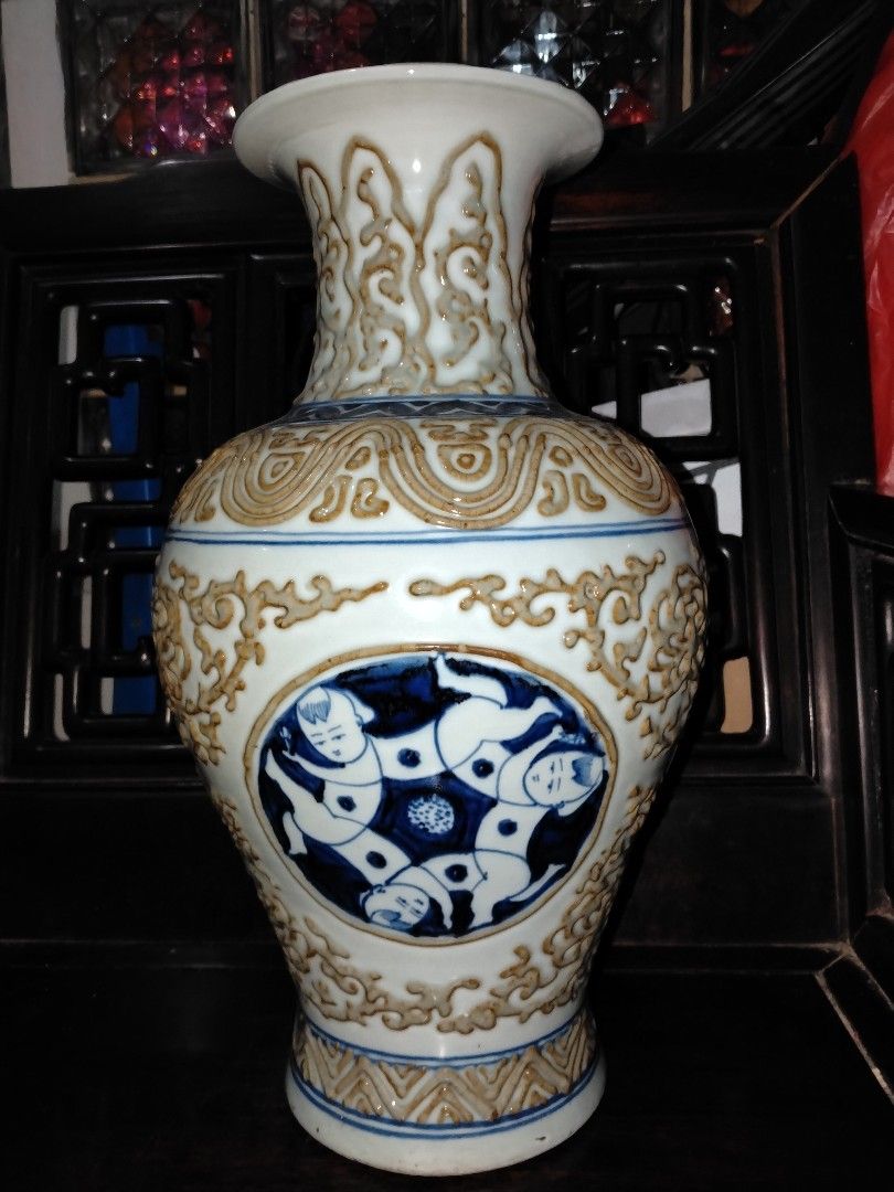 Ming's Style Kids Vase (Category: Vases & Decorative Bowls) located in Johor Bahru. Submitted by oldteapot (Listing ID 1446856944, Image 1). Description: Antique Chinese blue and white porcelain vase resembles styles from the Ming or Qing dynasties, featuring intricate hand-painted motifs and a glazed finish. Design: The vase showcases detailed blue-on-white figurative or landscape scenes surrounded by ornate white relief patterns. Material: It i