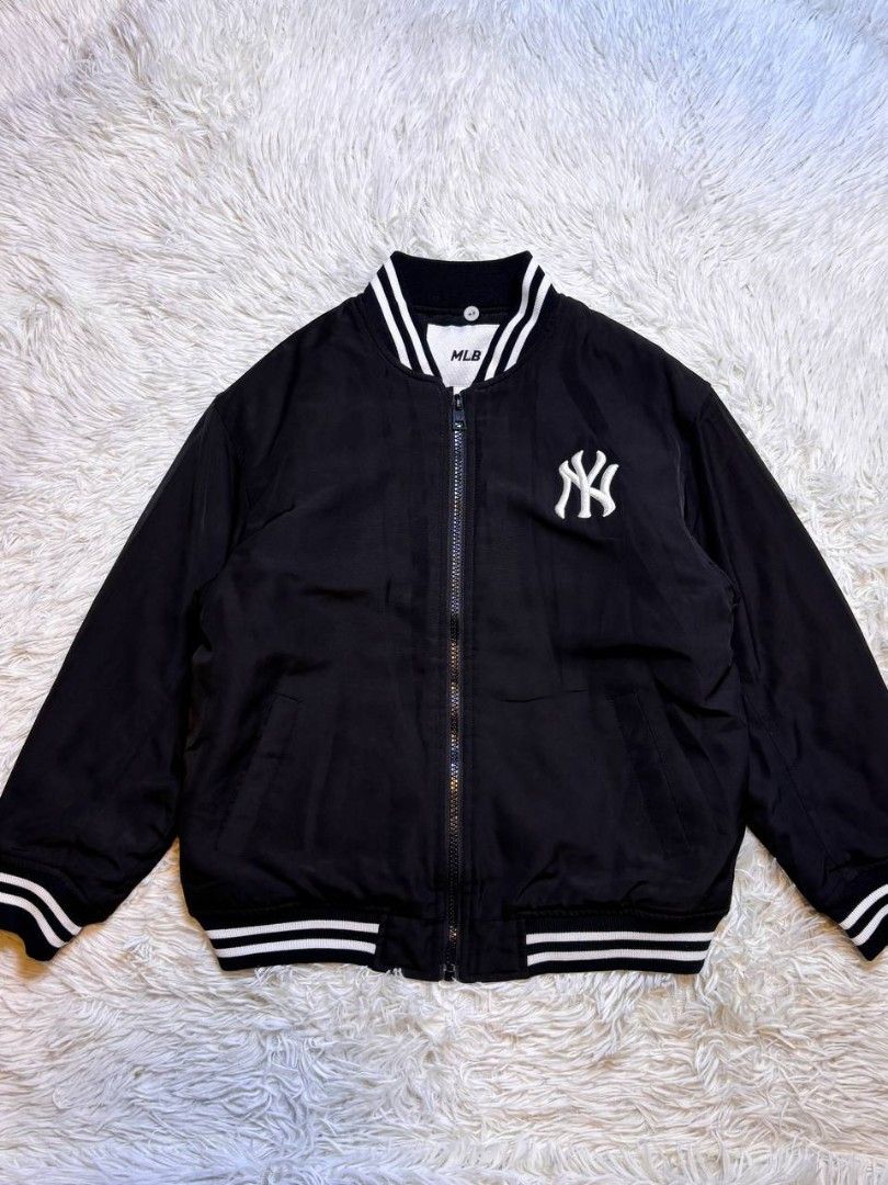 MLB New York Yankees Bomber Jacket Black White (Category: Babies & Kids Fashion) located in Catbalogan. Submitted by kristinapi (Listing ID 1446816181, Image 2). Description: - Classic black bomber jacket - Iconic NY Yankees logo on the back - White striped cuffs and collar - MLB branding on chest and inside label - Quilted lining for added warmth - Ideal for any New York Yankees fan.