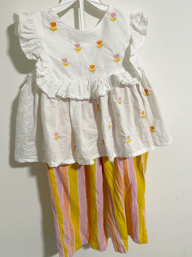 Next Set (3-4Y) (Category: Babies & Kids Fashion) located in Kuala Lumpur. Submitted by mom_and_daughter_preloved (Listing ID 1446824008, Image 1). Description: - Adorable white top with charming ruffled sleeves. - Features delicate embroidered tulip details on the top. - Comes with matching striped pants in vibrant pink, yellow, and orange. - Ideal for sunny summer days. - Offers both comfort and style for your child. - Versatile for easy wear a