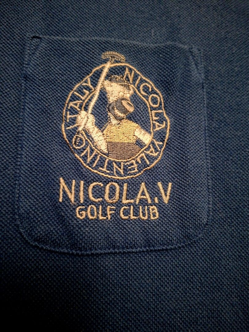 Vintage Nicola Valentino Italy (Category: Activewear) located in Antipolo. Submitted by d.tuazon (Listing ID 1446847099, Image 3). Description: This blue Nicola Valentino polo shirt features contrasting white trim on the collar and a golf club embroidered logo on the chest pocket. Nicola Valentino Italy, a vintage-style label often associated with 1990s Italian designer aesthetic.This particular label are typically found in the vintage markets.Si