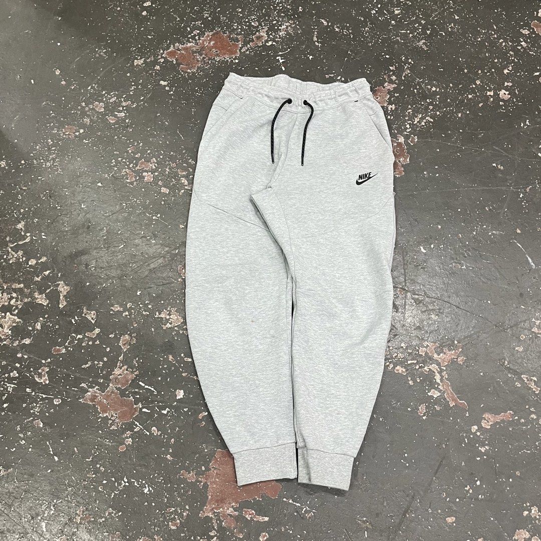 Nike Tech Fleece Grey Jogger Pants (Category: Joggers) located in Cagayan de Oro. Submitted by sumamestreethub (Listing ID 1446763386, Image 1). Description: - Grey Nike Tech Fleece joggers - Classic Nike logo on left leg - Zippered pocket on right side - Drawstring waist for adjustable fit - Tapered fit with elastic cuffs - Ideal for everyday wear or workouts W-Free L-35 T-12 H-4.