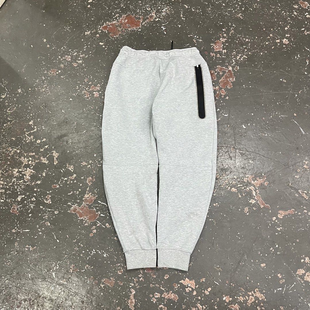 Nike Tech Fleece Grey Jogger Pants (Category: Joggers) located in Cagayan de Oro. Submitted by sumamestreethub (Listing ID 1446763386, Image 2). Description: - Grey Nike Tech Fleece joggers - Classic Nike logo on left leg - Zippered pocket on right side - Drawstring waist for adjustable fit - Tapered fit with elastic cuffs - Ideal for everyday wear or workouts W-Free L-35 T-12 H-4.