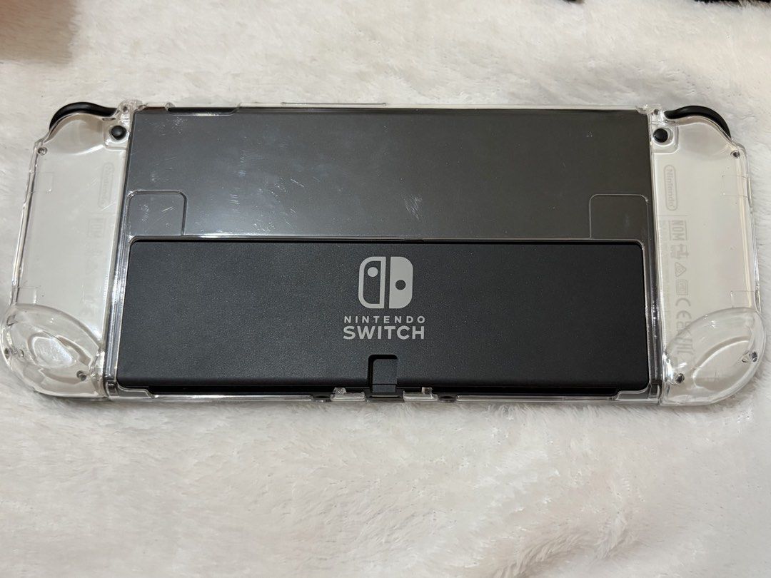 Nintendo Switch OLED Console (White) (Category: Nintendo) located in San Fernando. Submitted by cscg_ (Listing ID 1446835724, Image 3). Description: Nintendo Switch OLED Console (White) - Excellent condition - No issues, fully functional - Bought March 2026 - Complete set w/ original inclusions/accessories - Freebies: Dockable transparent case, tempered glass, and charging controller grip bracket - RFS: Rarely used Also available: SanDisk Extreme