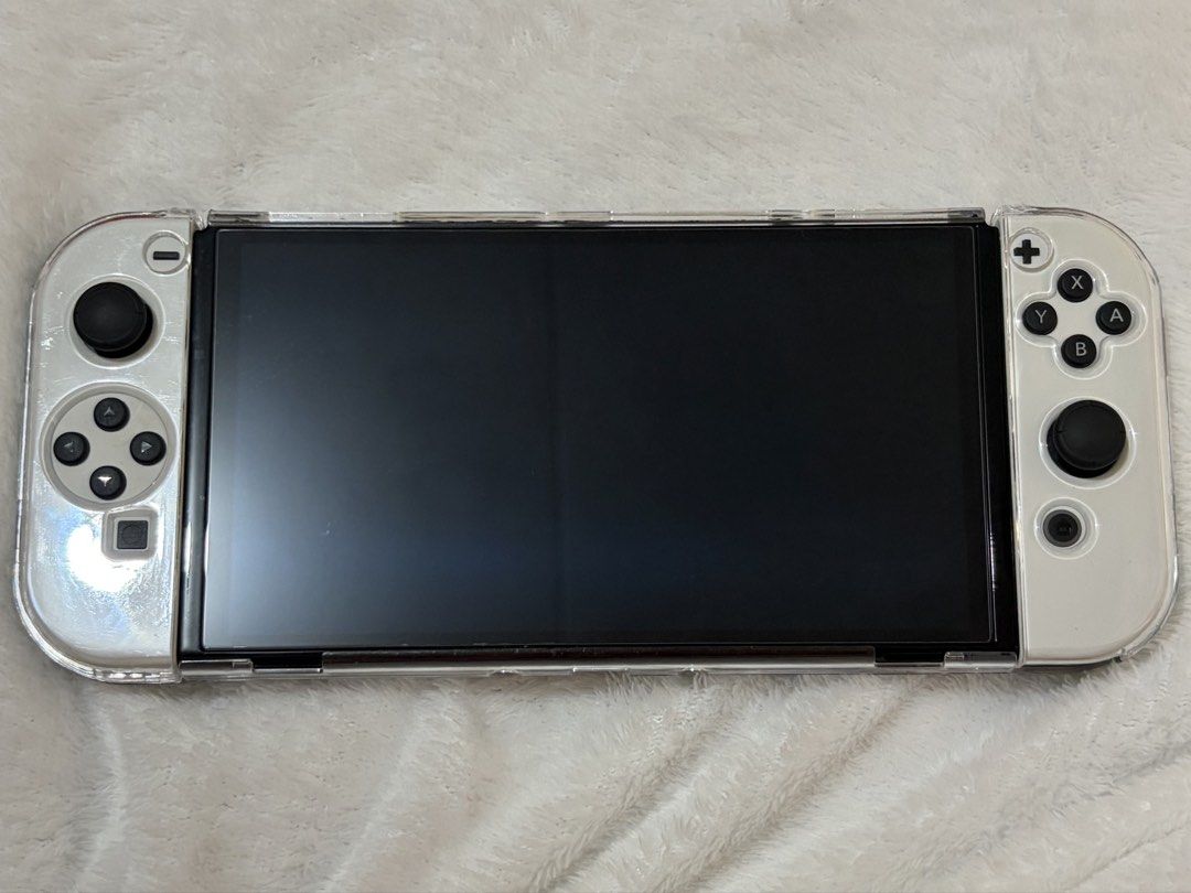 Nintendo Switch OLED Console (White) (Category: Nintendo) located in San Fernando. Submitted by cscg_ (Listing ID 1446835724, Image 2). Description: Nintendo Switch OLED Console (White) - Excellent condition - No issues, fully functional - Bought March 2026 - Complete set w/ original inclusions/accessories - Freebies: Dockable transparent case, tempered glass, and charging controller grip bracket - RFS: Rarely used Also available: SanDisk Extreme