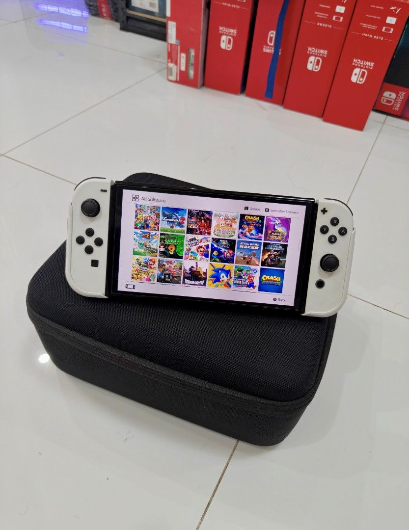Nintendo Switch Oled White with Games (Category: Nintendo) located in Manila. Submitted by nswitchgear (Listing ID 1446799863, Image 2). Description: Nintendo Switch OLEDs with Free Games ₱10,999 FREE acess to my Paid games Legit purchase not Jailbreak. Preloved with minor sign of usage. Can give 7 Days personal Warranty for peace of mind. -Doon po tayo sa kaya tayong issupport, dont settle for less. Comes w/ Complete Package with pouch (Travelba