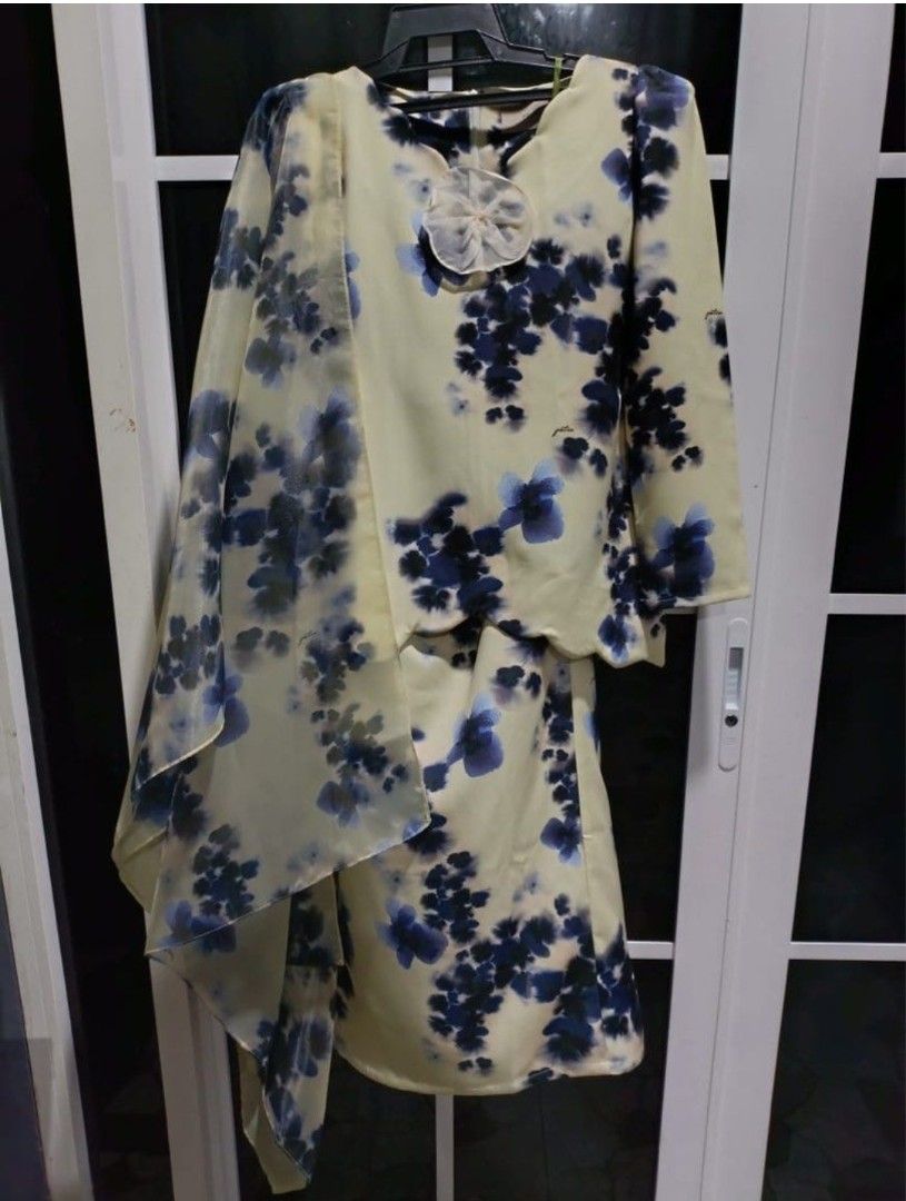 Petra Cream Floral Baju Kurung Set with Shawl (Category: Baju Kurung & sets) located in Labu. Submitted by yuyupreloved14 (Listing ID 1446820121, Image 2). Description: - Elegant cream Baju Kurung set - Features a beautiful blue floral print - Long sleeves for comfortable coverage - Matching skirt included - Comes with a sheer, elegant shawl - Unique floral embellishment at the neckline - Ideal for events, parties, and festive celebrations - Easy