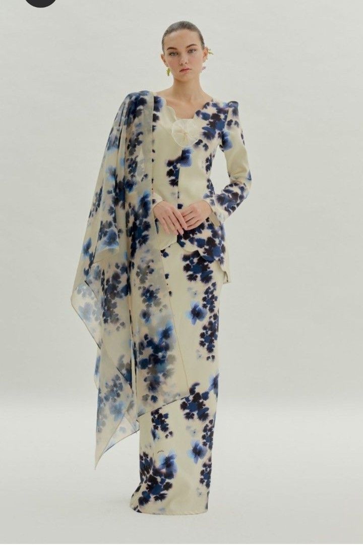 Petra Cream Floral Baju Kurung Set with Shawl (Category: Baju Kurung & sets) located in Labu. Submitted by yuyupreloved14 (Listing ID 1446820121, Image 1). Description: - Elegant cream Baju Kurung set - Features a beautiful blue floral print - Long sleeves for comfortable coverage - Matching skirt included - Comes with a sheer, elegant shawl - Unique floral embellishment at the neckline - Ideal for events, parties, and festive celebrations - Easy
