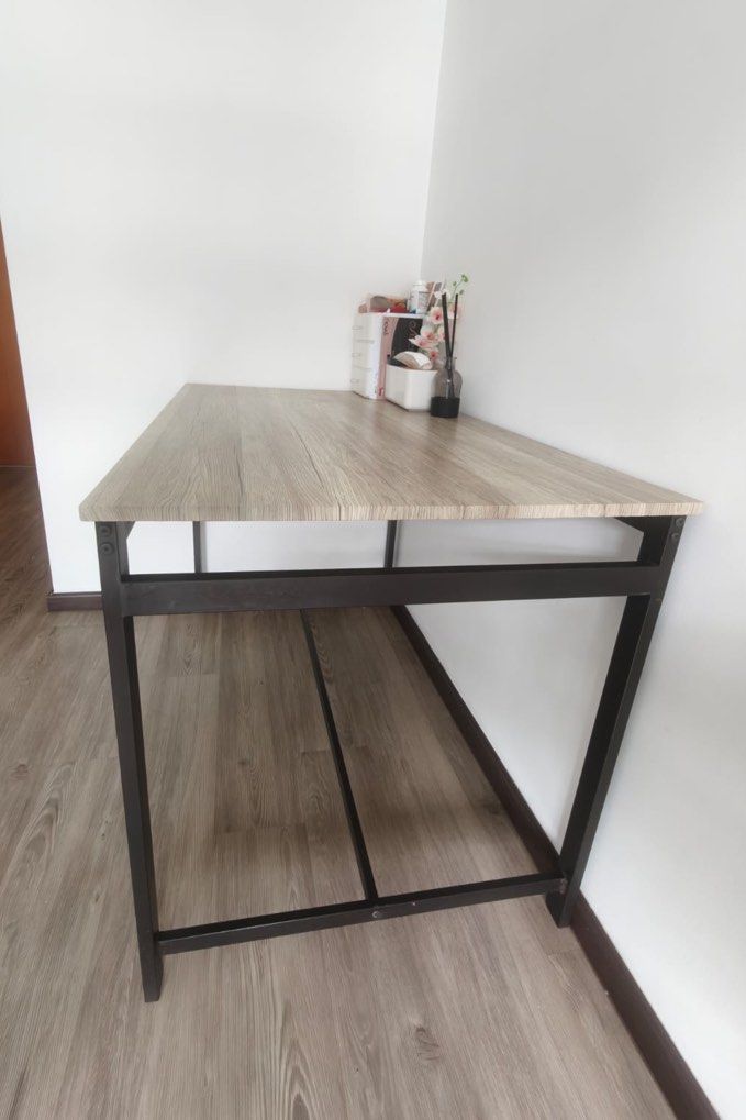 Pine Dining Table (Category: Tables & Sets) located in Singapore. Submitted by potrock908 (Listing ID 1446783721, Image 2). Description: 4-seater dining table: - Table only, no chairs - Height 75cm, width 110cm, depth 70cm - Wood top, metal frame - Light pine/greyish wood colour quite true to the picture - Well-loved but also very well-taken cared of, with no visible peeling or scratches - One discoloured part of the wood as shown in picture 3, t