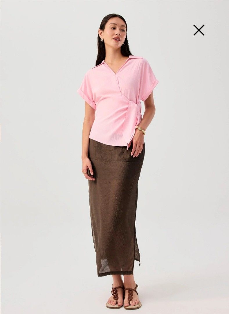 Pink Short Sleeve Wrap Tie Top (Category: Blouses) located in Manila. Submitted by mscloudnine (Listing ID 1446799523, Image 2). Description: - Cute pink wrap top - Short sleeves - Features a tie detail at the waist - Collar neckline - Perfect for dressing up or down -Cut with drop shoulders and a breathable fabric - Please check measurements for the best fit Retails for 1,990.00 Selling as low as 1,550.00 BRANDNEW with tag.