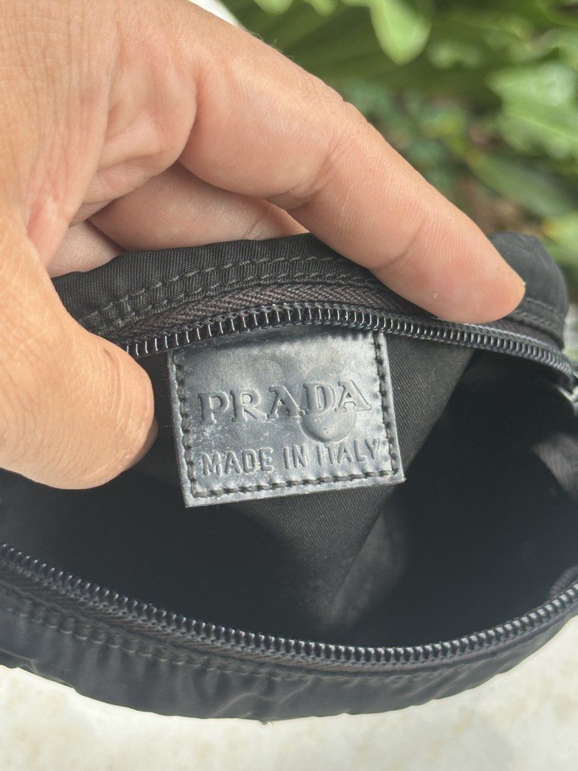 Prada Nylon Pouch Made in Italy (Category: Luxury Bags & Wallets) located in Bustos. Submitted by theprelovedshopbulacan (Listing ID 1446739265, Image 3). Description: - Authentic Prada pouch - Black nylon material - Zipper closure - Interior: 'PRADA MADE IN ITALY' leather tag and size tag '8' - Small and compact, perfect for carrying essentials.