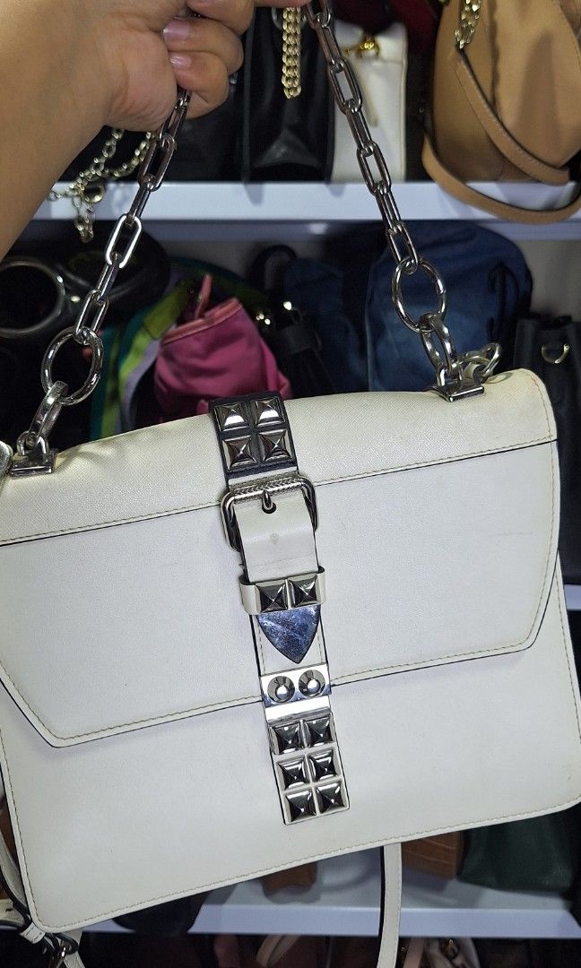 Prada sling bag (Category: Luxury Bags & Wallets) located in Quezon City. Submitted by little.tinderella (Listing ID 1446803815, Image 1). Description: May issues po and NGA. Please inspect photos for the condition of the bag. May missing studs and hairline Crack sa leather..