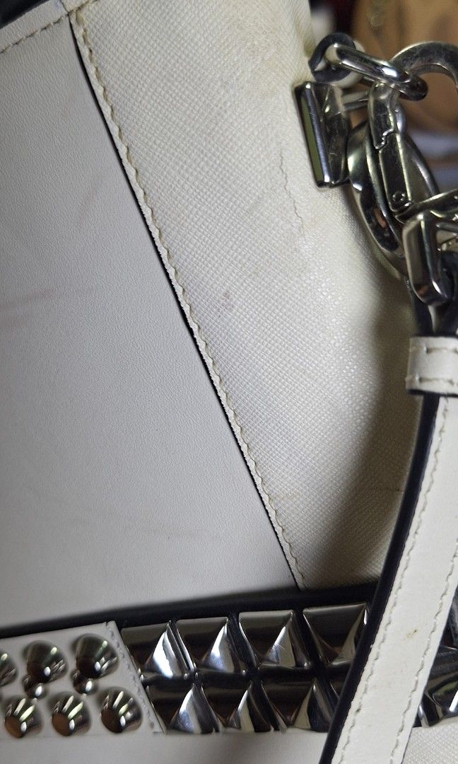 Prada sling bag (Category: Luxury Bags & Wallets) located in Quezon City. Submitted by little.tinderella (Listing ID 1446803815, Image 3). Description: May issues po and NGA. Please inspect photos for the condition of the bag. May missing studs and hairline Crack sa leather..