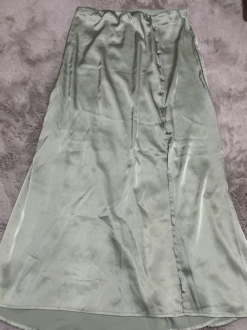 Sage Green Satin Button Front Midi Skirt (Category: Skirts) located in Manila. Submitted by acbdacbd (Listing ID 1446885874, Image 1). Description: - Flowy midi skirt - Lovely sage green color - Satin material with a nice sheen - Button-up front - Features a slit - Perfect for dressing up or down - Ideal for night outs or casual days - Easy to style with various tops.