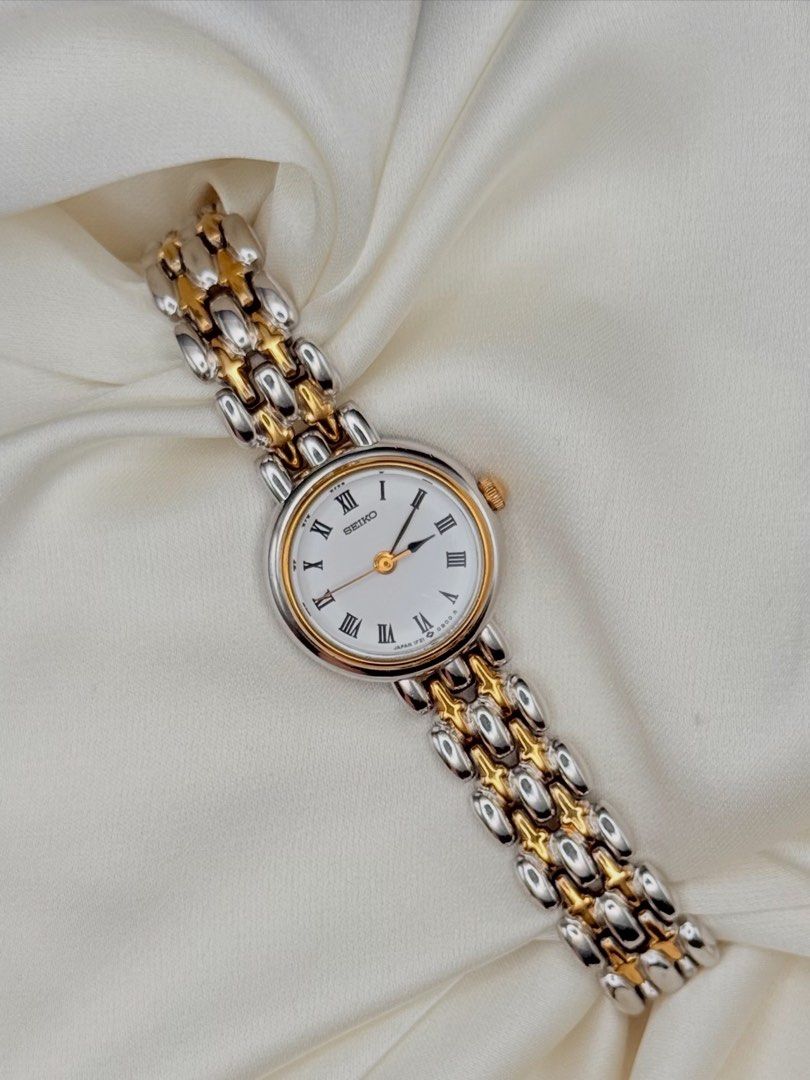Seiko Classic Roman Two Toned Watch (Category: Women's Watches) located in Lipa City. Submitted by watchoutph (Listing ID 1446826588, Image 1). Description: Seiko Classic Dainty Two-toned Watch White Dial Roman Indices Royal spade hands Silver round case with gold ring bezel Elegant Quartz 25mm 16.3cm wrist size ₱8,500.