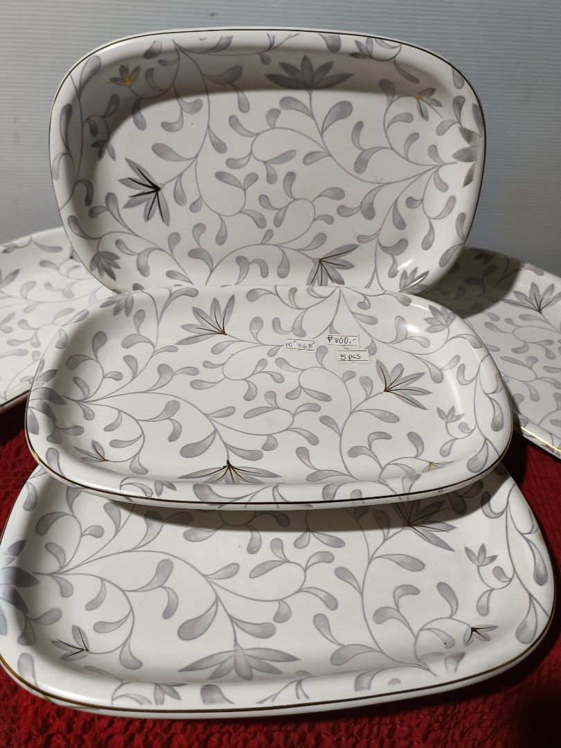 Set of 5 Rectangular ceramic serving platters with Floral Design (Category: Dinnerware & Cutlery) located in Muntinlupa City. Submitted by mcjek1026 (Listing ID 1446727311, Image 2). Description: - Set of 5 rectangular ceramic serving platters - Lovely grey and white floral pattern with gold trim - Ideal for serving snacks, appetizers, or desserts - Perfect for parties or everyday use - Approximate dimensions: 10" x 6.5" .