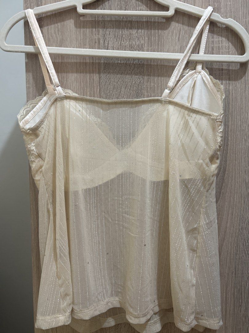Sheer Lace Trim Camisole Top (Category: Sleeveless) located in Mandaluyong City. Submitted by izz_iya (Listing ID 1446775702, Image 2). Description: - price negotiable - Cream colored camisole - Sheer, sparkly fabric - Adjustable straps for a customized fit - Estimated size: Medium -bought from vintage/thrift ig stores -rfs: I wasn’t able to use it for an event/declutterring .
