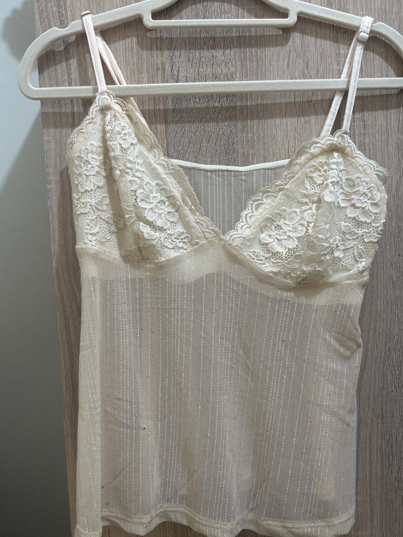 Sheer Lace Trim Camisole Top (Category: Sleeveless) located in Mandaluyong City. Submitted by izz_iya (Listing ID 1446775702, Image 1). Description: - price negotiable - Cream colored camisole - Sheer, sparkly fabric - Adjustable straps for a customized fit - Estimated size: Medium -bought from vintage/thrift ig stores -rfs: I wasn’t able to use it for an event/declutterring .