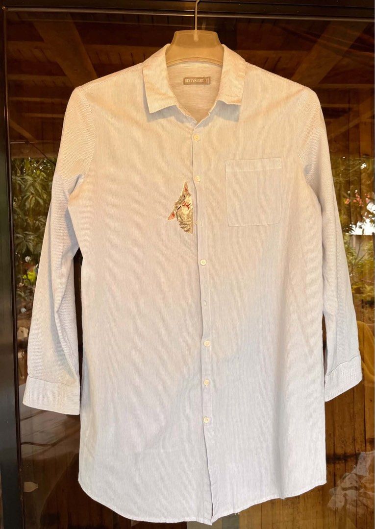Sixty8ight Striped Button-Up Shirt with Cat Embroidery (Category: Shirts) located in Iloilo. Submitted by wanderzee (Listing ID 1446731091, Image 1). Description: - Light blue and white striped button-up shirt - Adorable embroidered cat detail peeking from pocket - Long sleeves, can be cuffed for versatile styling - Ideal for casual everyday wear - Tagged size 11 -lakas maka rich-tita vibe Bust 40” Shoulder 16” Length 32” .