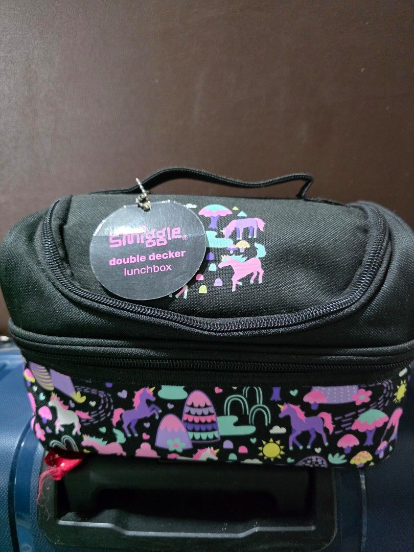 Smiggle Double Decker Lunchbox Unicorn Rainbow Print (Category: Babies & Kids Fashion) located in Rizal. Submitted by cluttercleanup (Listing ID 1446757593, Image 1). Description: - Smiggle Double Decker Lunchbox - Color: Black with unicorn and rainbow print - Features two spacious compartments - Insulated interior to keep food fresh - Zippers are in excellent working condition, minor paint nicks - Ideal for school lunches or snacks for kids - un